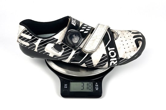 Mass manufactured shoe with an over-the-counter orthotic.